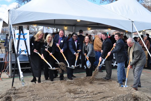 Groundbreaking attendees shovel earth in a ceremony to kick off construction for the Stacie Mathewson Community Wellness Center in January 2015.