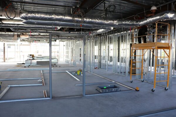 Construction workers begin to create the room frames for the second floor Wellness Pod.