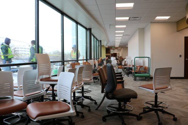 Workers put the finishing touches on the Stacie Mathewson Community Wellness Center as the furniture for the building is brought in.