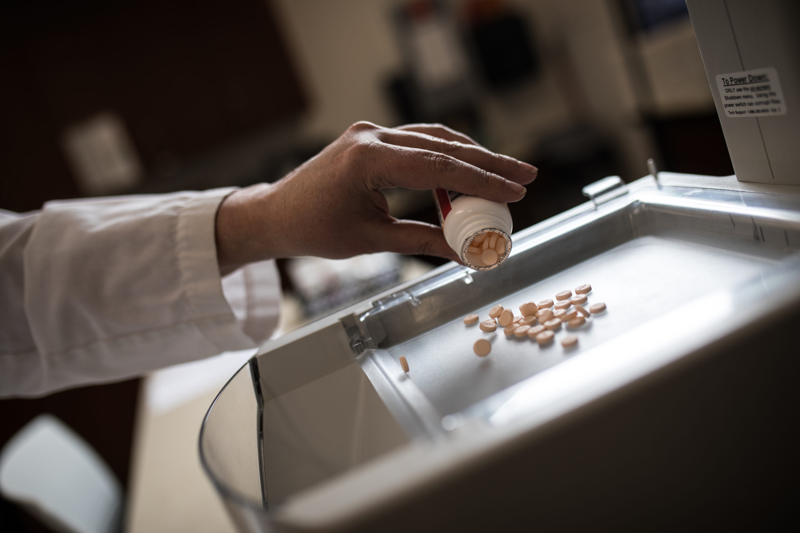 Prescription drugs being measured in pharmacy tray